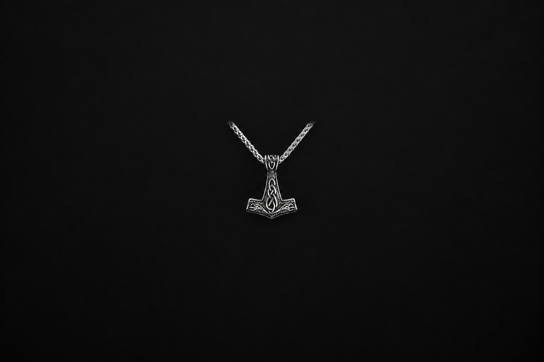 Silver Viking hammer necklace with chain shown completely inside a wide, dark background margin for blog-card cropping.