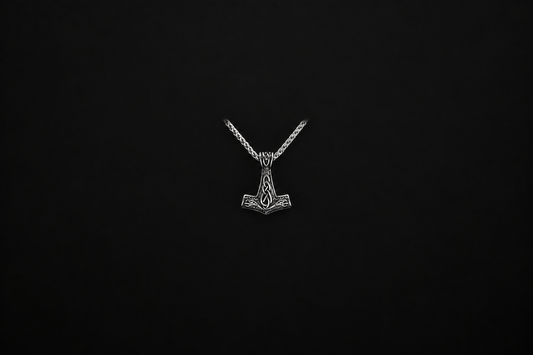 Silver Viking hammer necklace with chain shown completely inside a wide, dark background margin for blog-card cropping.