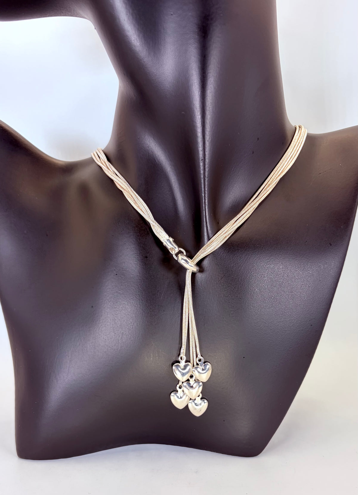 Five-heart drop necklace and multi-strand bracelet, group view