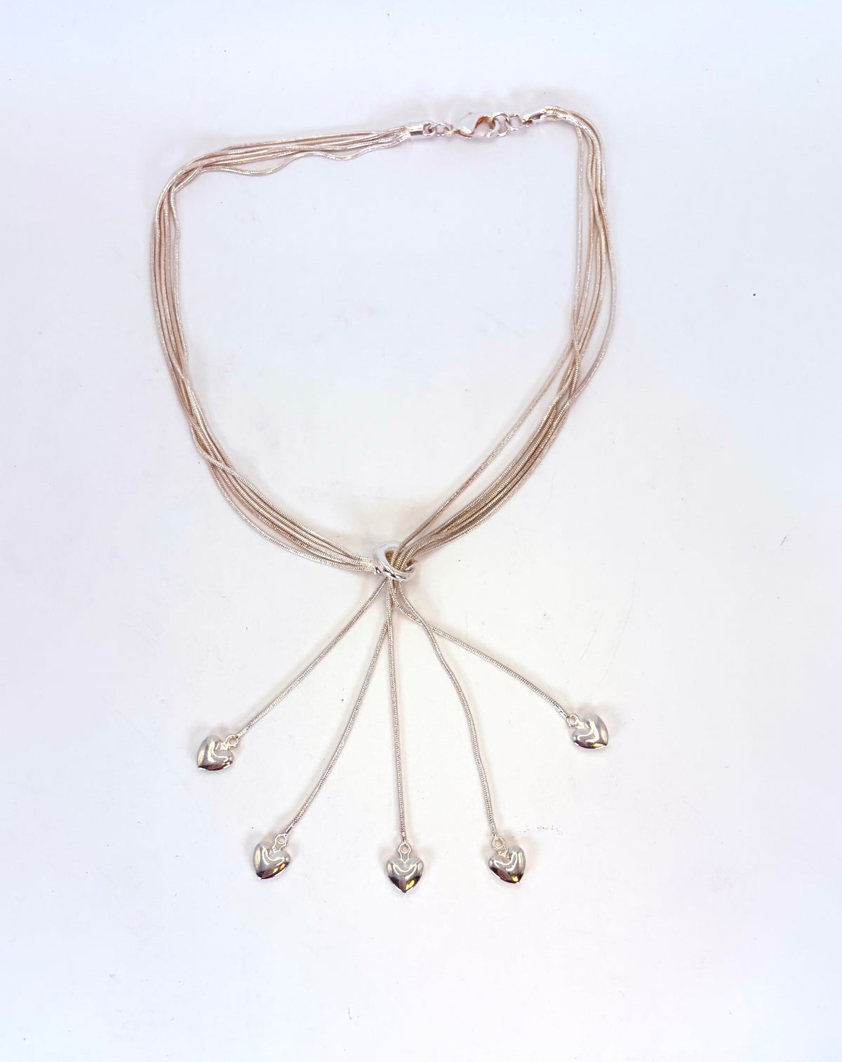Five-heart drop sterling silver necklace on display form