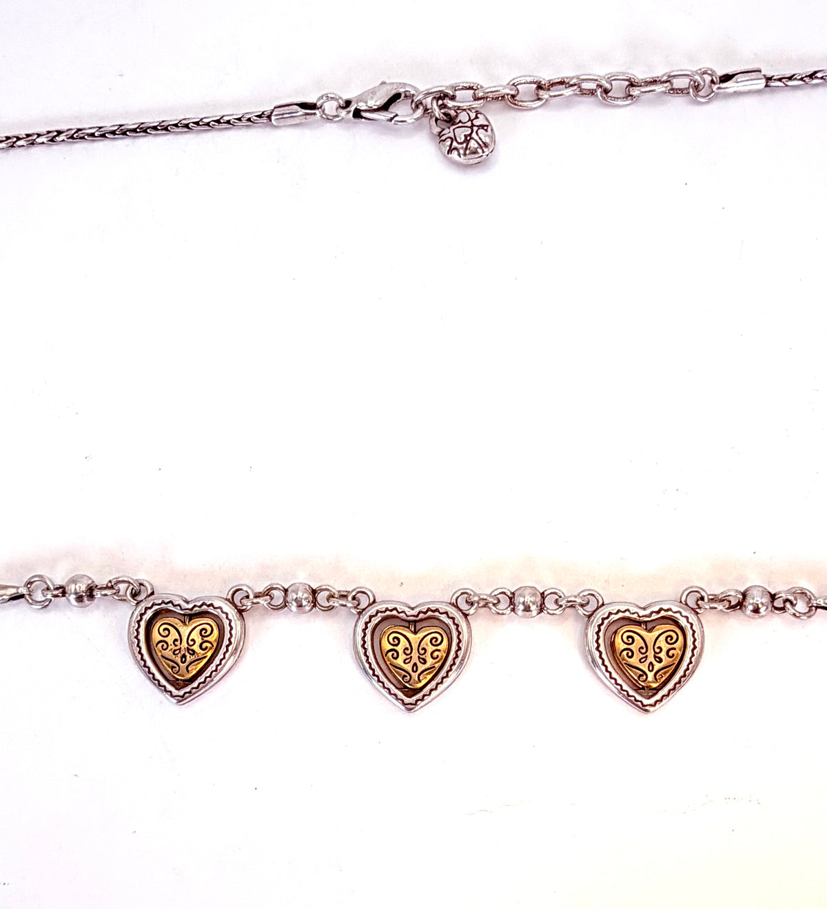 Details of three-heart necklace and clasp