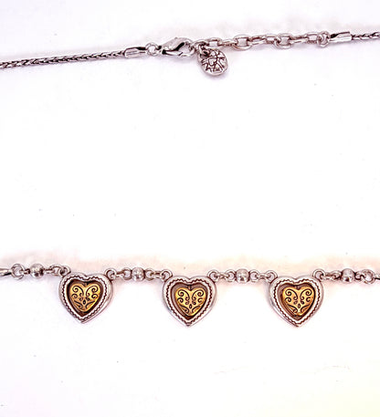 Details of three-heart necklace and clasp