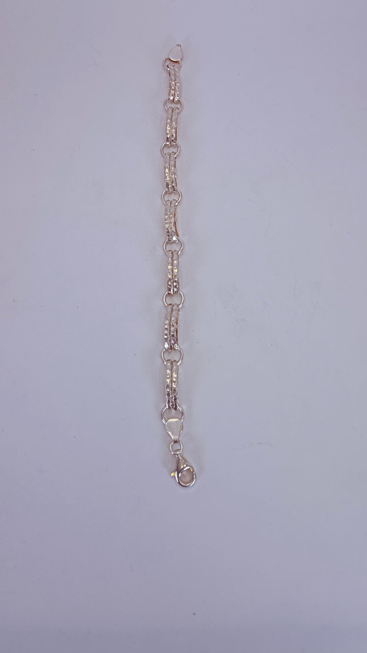Five-heart drop necklace laid flat