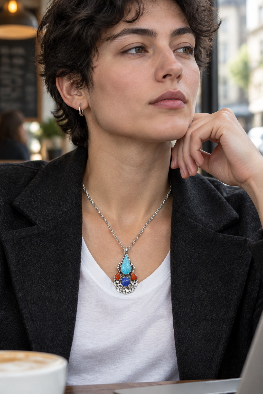 Blue teardrop pendant in a city café