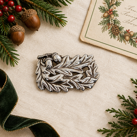 Brooch beside a holiday card and greenery