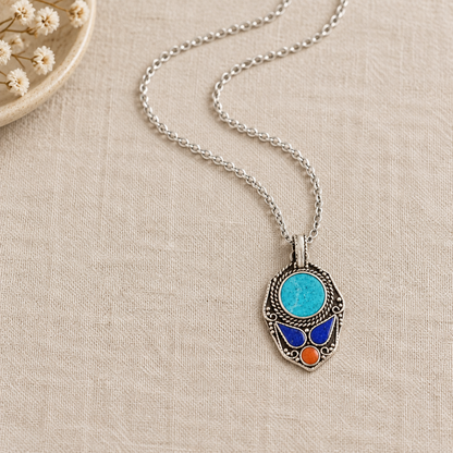 Oval blue pendant on a dressing table