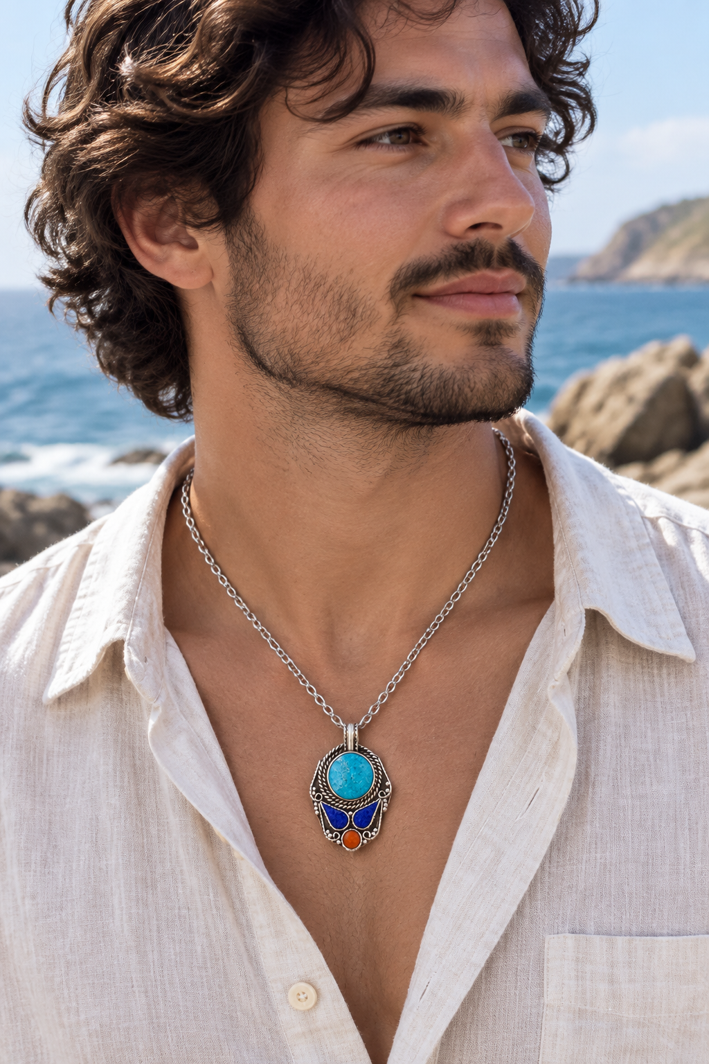 Oval blue pendant on a rocky coast